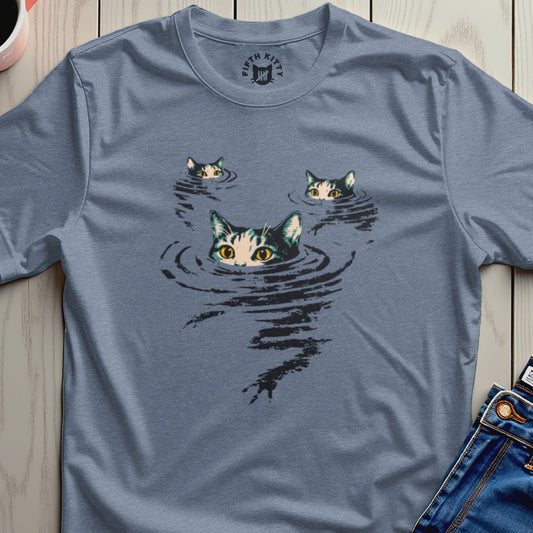 Three cats with green eyes peek out of dark water on a blue t-shirt.