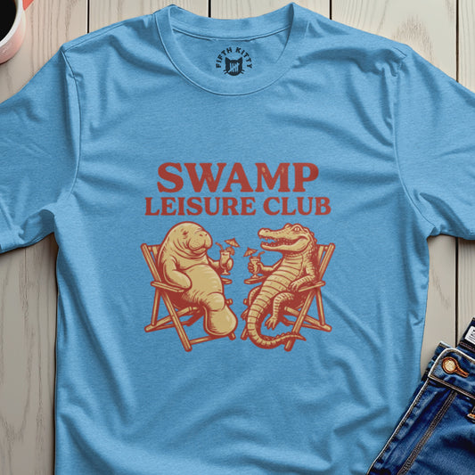 Blue t-shirt with "SWAMP LEISURE CLUB" logo and cartoon alligator and manatee.