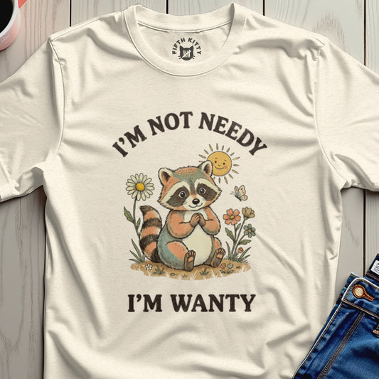 Cream t-shirt with raccoon graphic and "I'm Not Needy I'm Wanty" text.