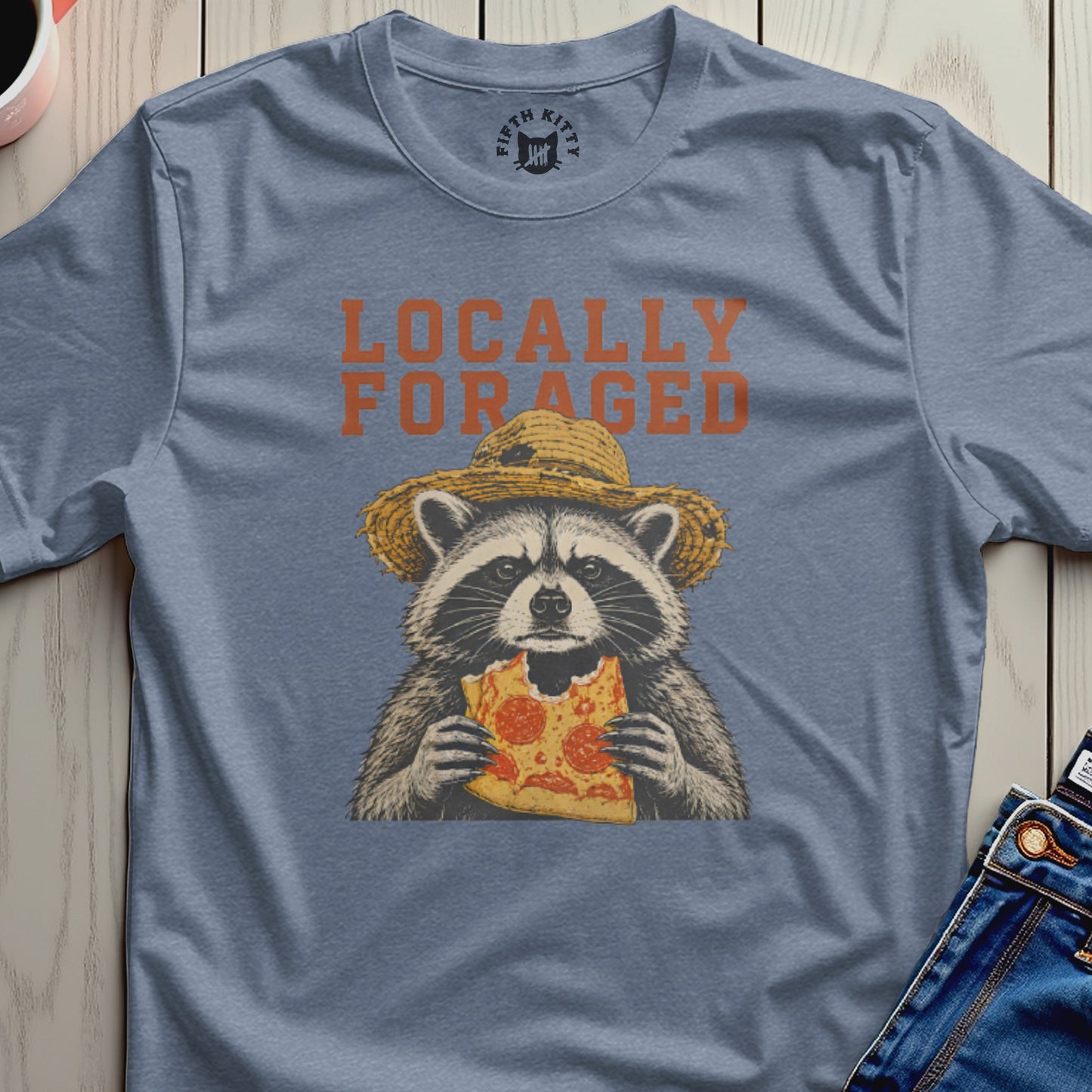 Raccoon wearing a straw hat eats a slice of pizza, "Locally Foraged" text above.
