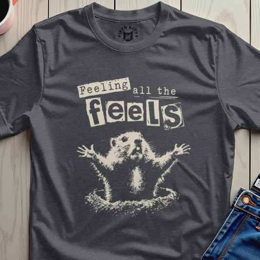Dark t-shirt with a groundhog bursting from dirt, text "Feeling all the feels".
