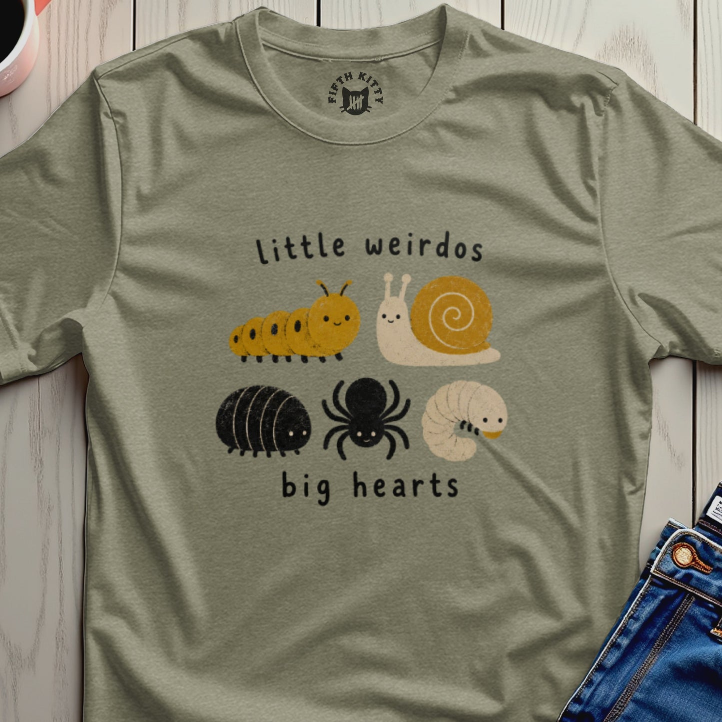 Green t-shirt with "little weirdos big hearts" text and illustrations of bugs.