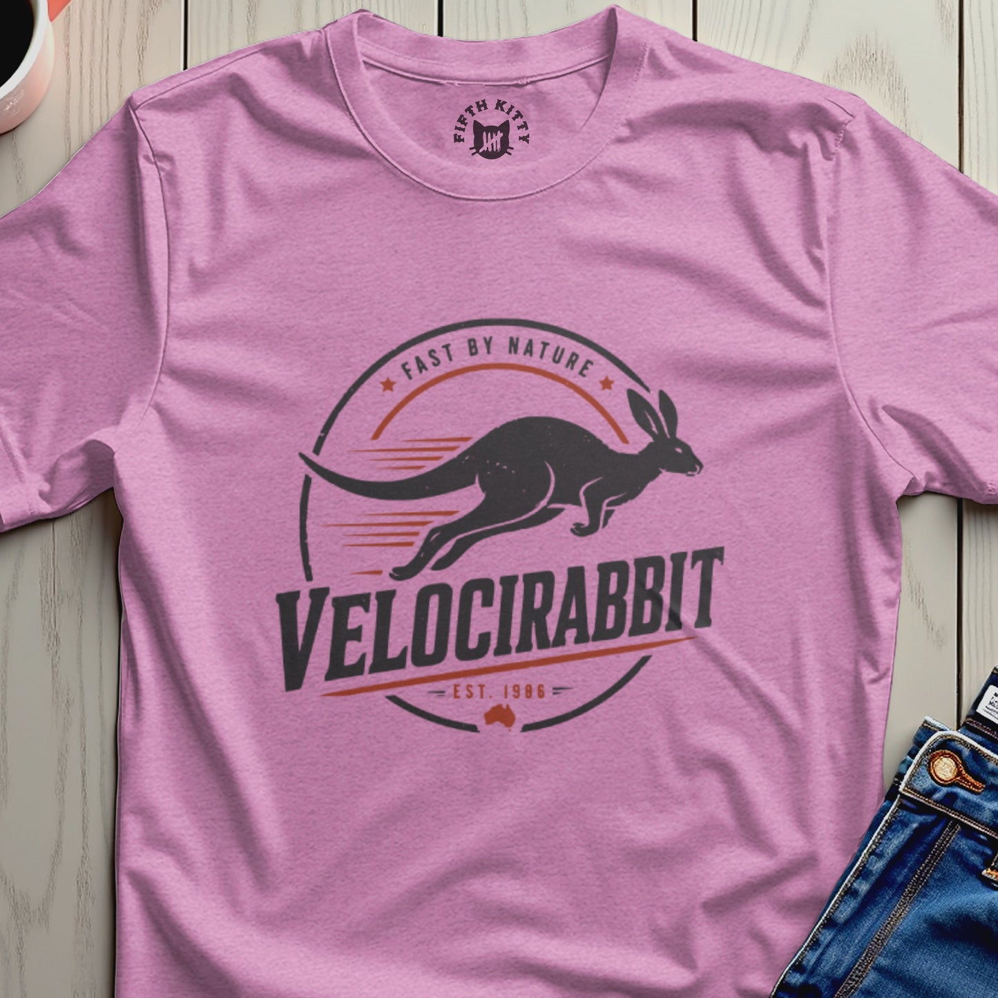Pink t-shirt with a dark graphic of a velociraptor-like rabbit and the text "Velocirabbit".