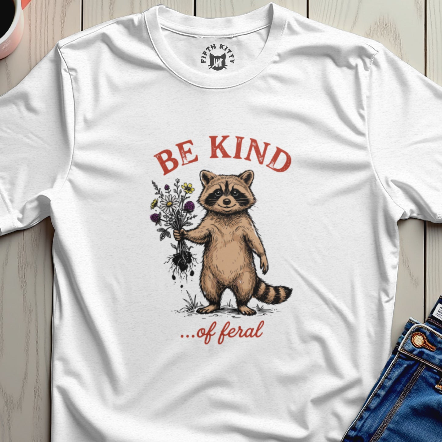 Raccoon holding a bouquet of flowers with "BE KIND ...of feral" text.