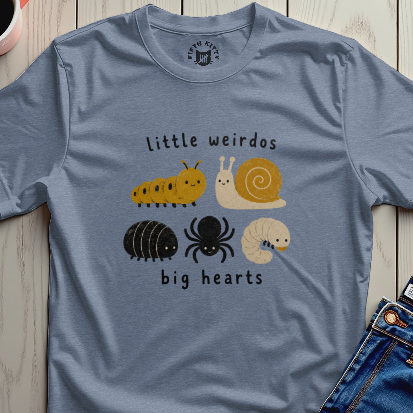 Blue t-shirt with "Little weirdos" and cartoon insect illustrations above "big hearts".
