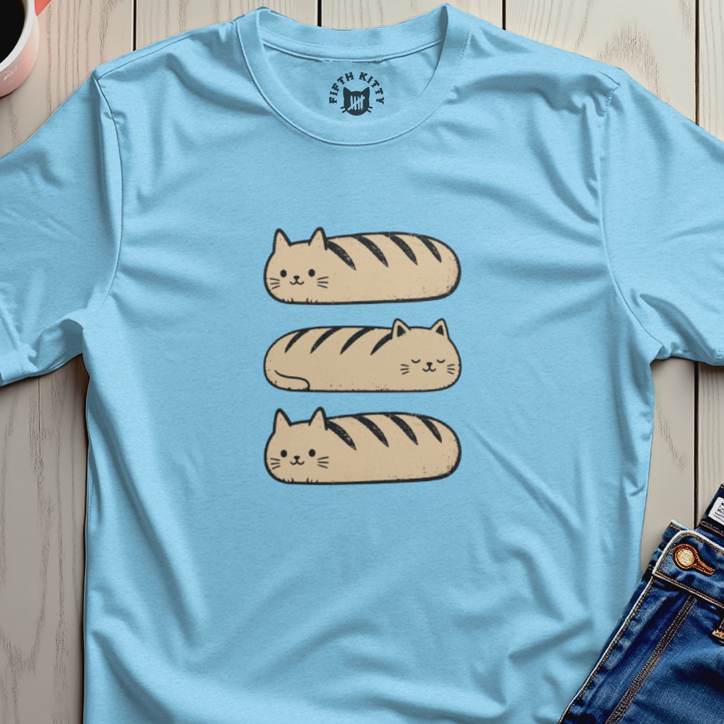 Light blue t-shirt with three brown bread-shaped cats stacked vertically.