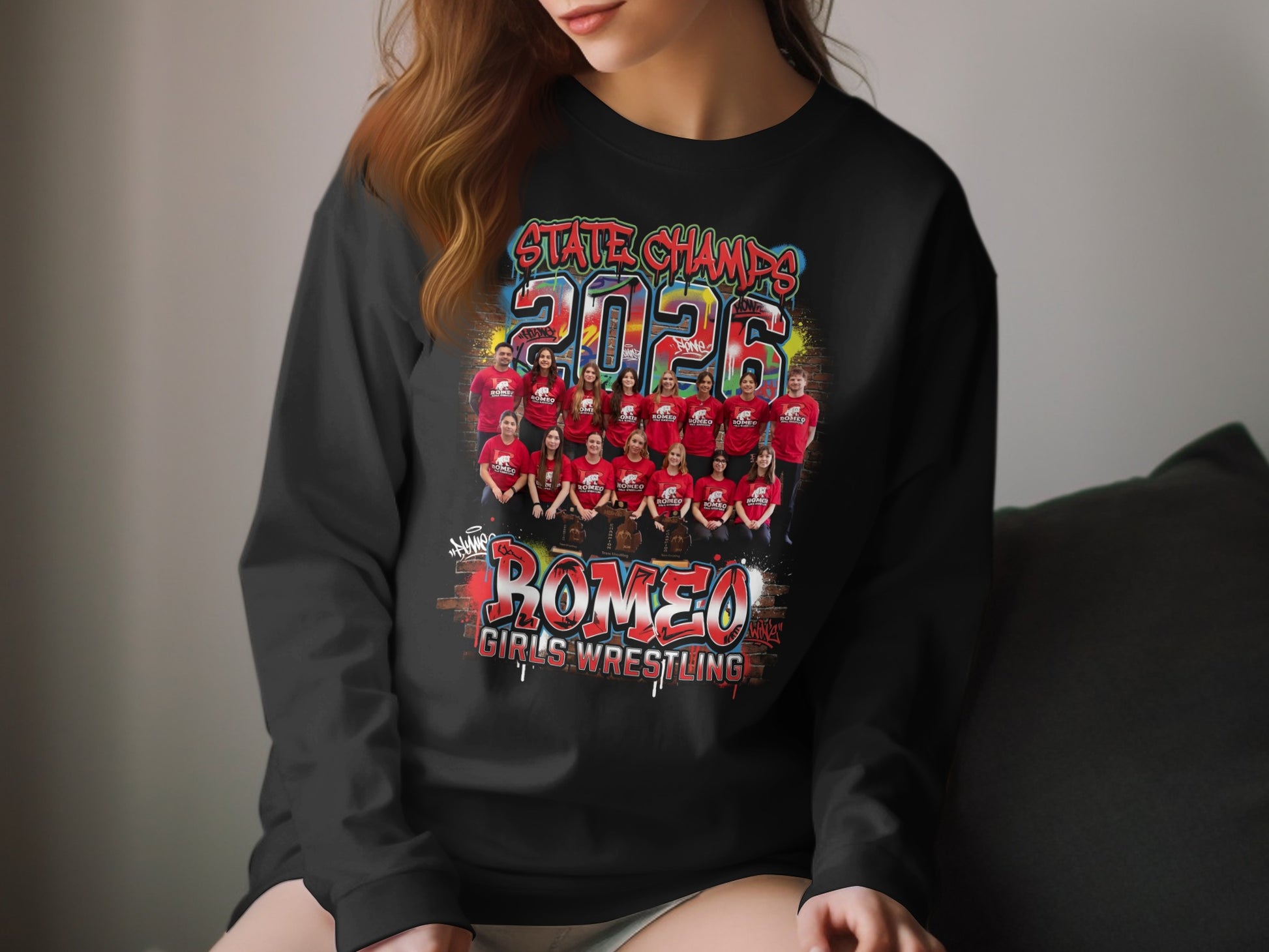 2026 State Champs Romeo Girls Wrestling team photo on black sweatshirt.
