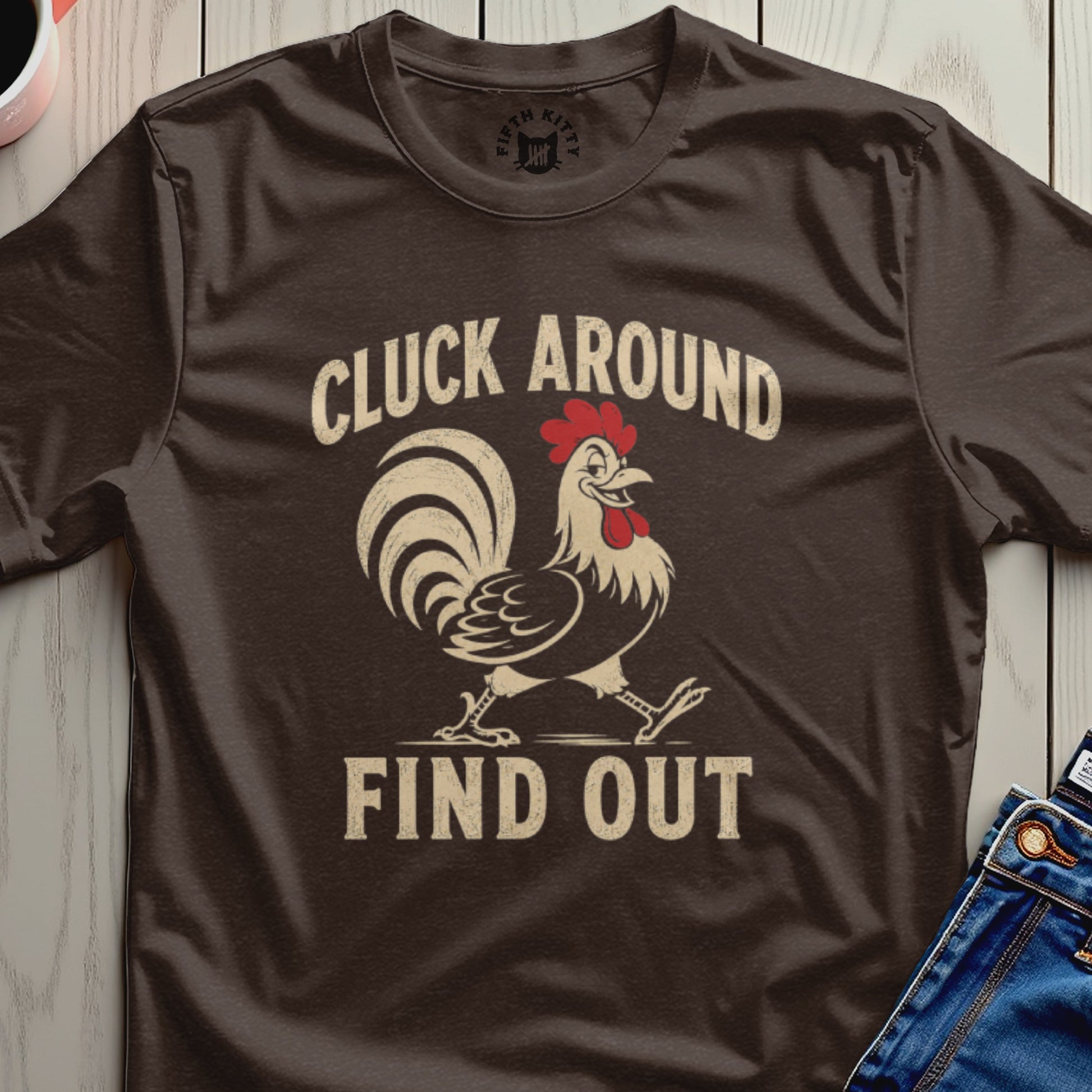 Brown t-shirt with a distressed graphic of a rooster and text "CLUCK AROUND FIND OUT".
