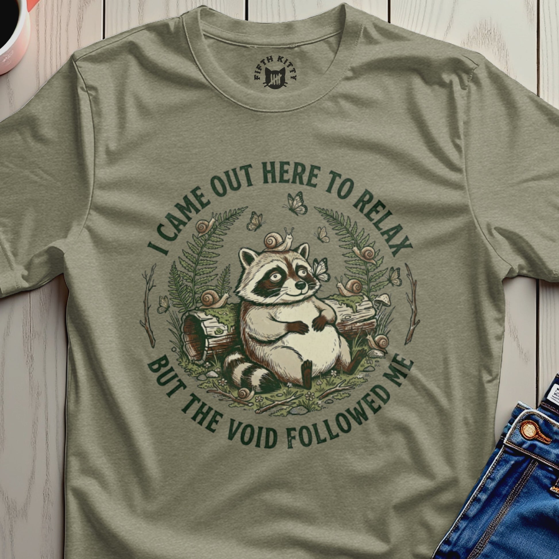 Raccoon sitting among logs, with text "I came out here to relax but the void followed me."