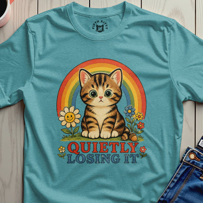 Teal t-shirt with a retro graphic of a tabby cat and rainbow, reads "QUIETLY LOSING IT."