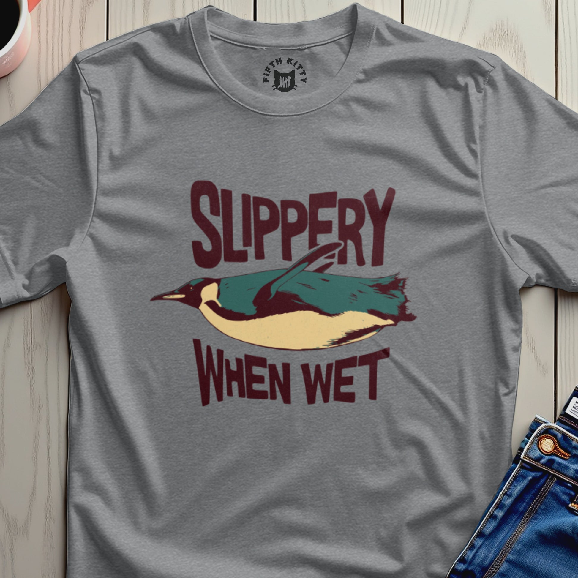Gray t-shirt with penguin graphic and "Slippery When Wet" text.