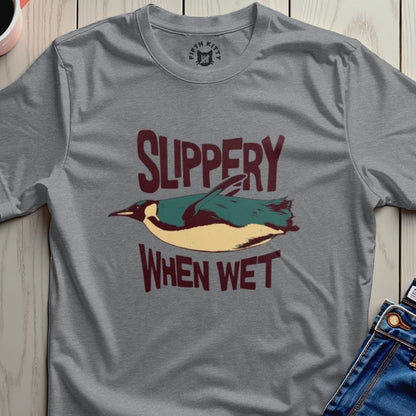 Gray t-shirt with penguin graphic and "Slippery When Wet" text.