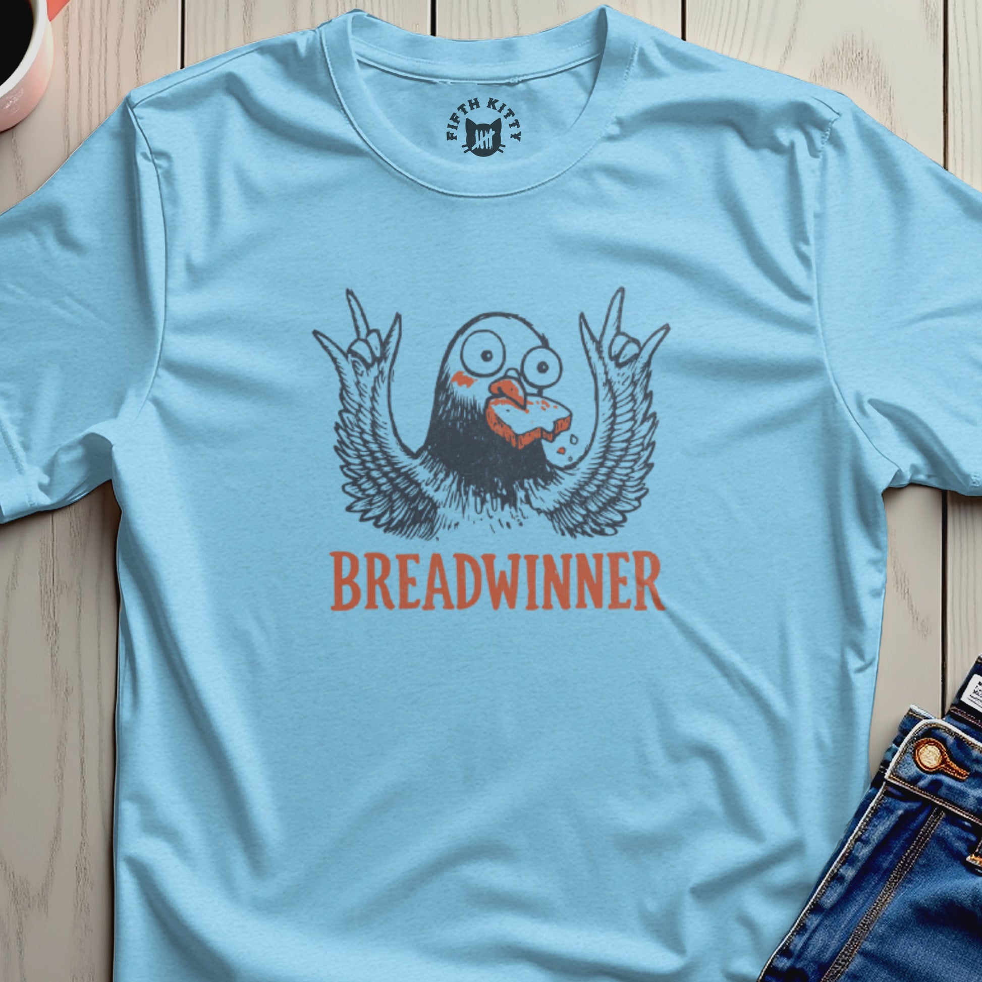 Light blue t-shirt with a cartoon bird holding bread and the text "BREADWINNER".
