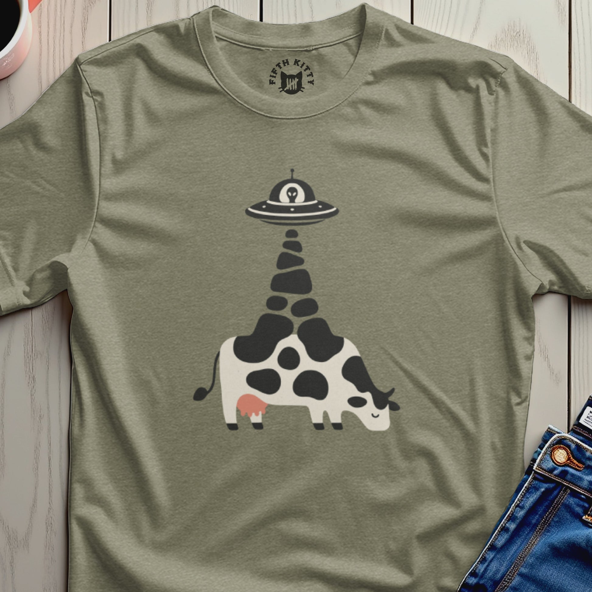 T-shirt with a cow being abducted by a UFO graphic.