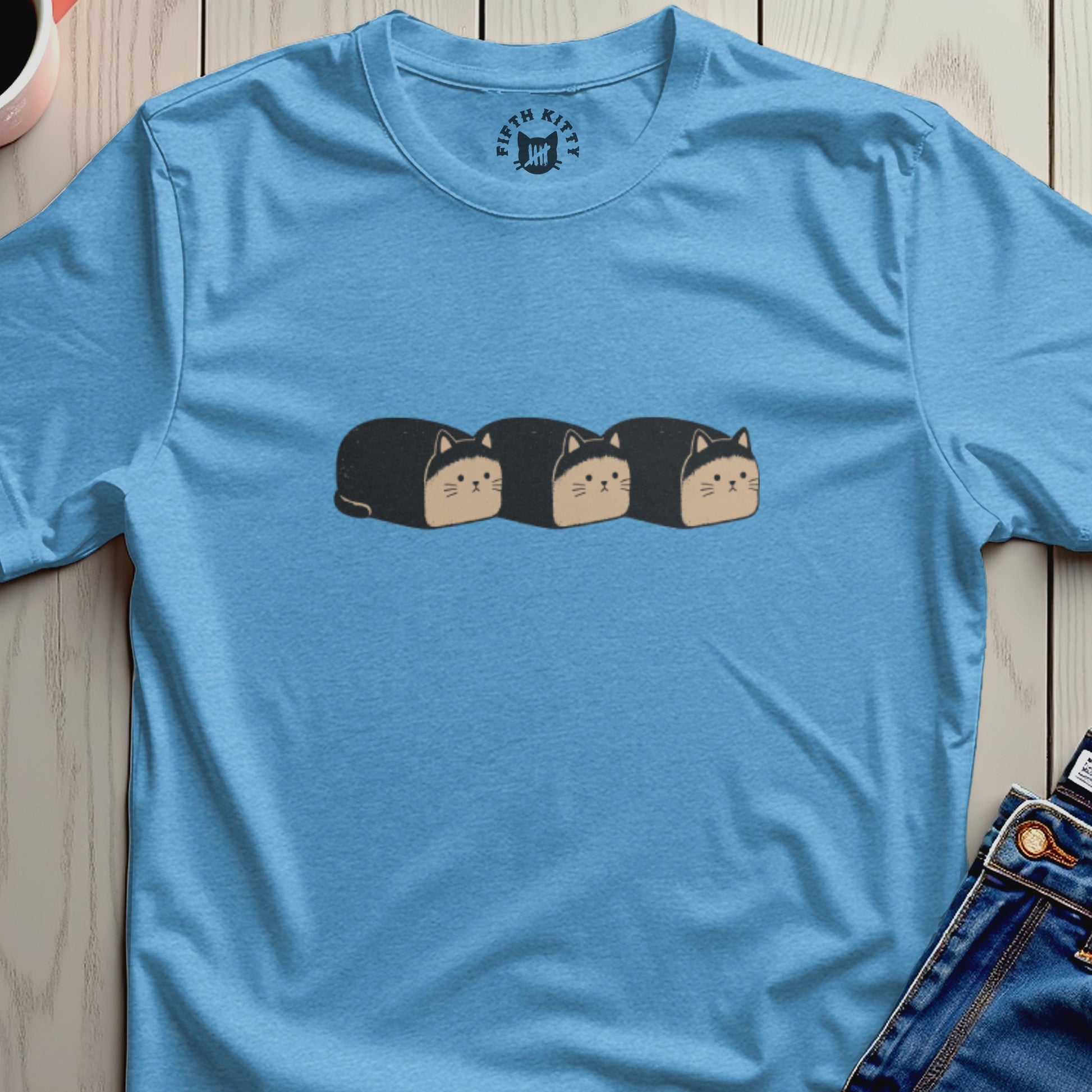 Light blue t-shirt with three loaf-shaped cats graphic and Fifth Kitty logo on collar.