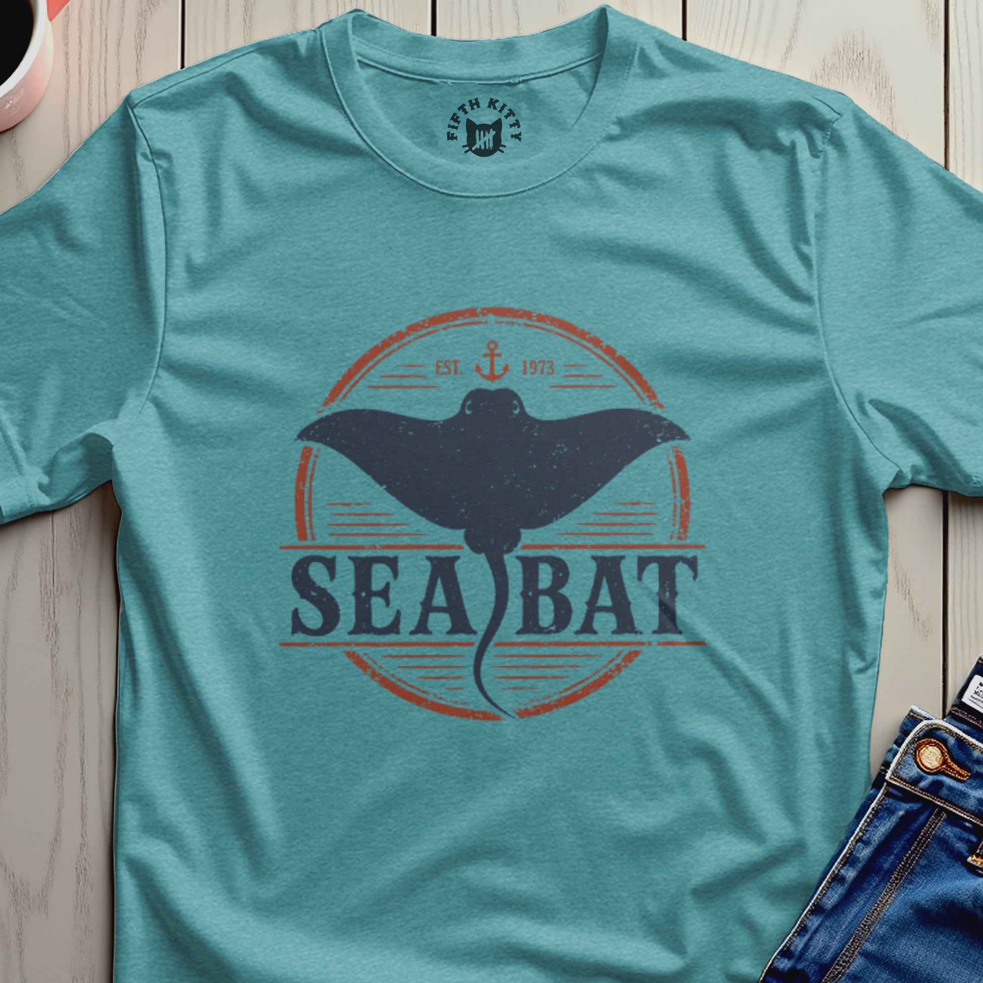 Teal t-shirt with "Sea Bat" text and a manta ray graphic.