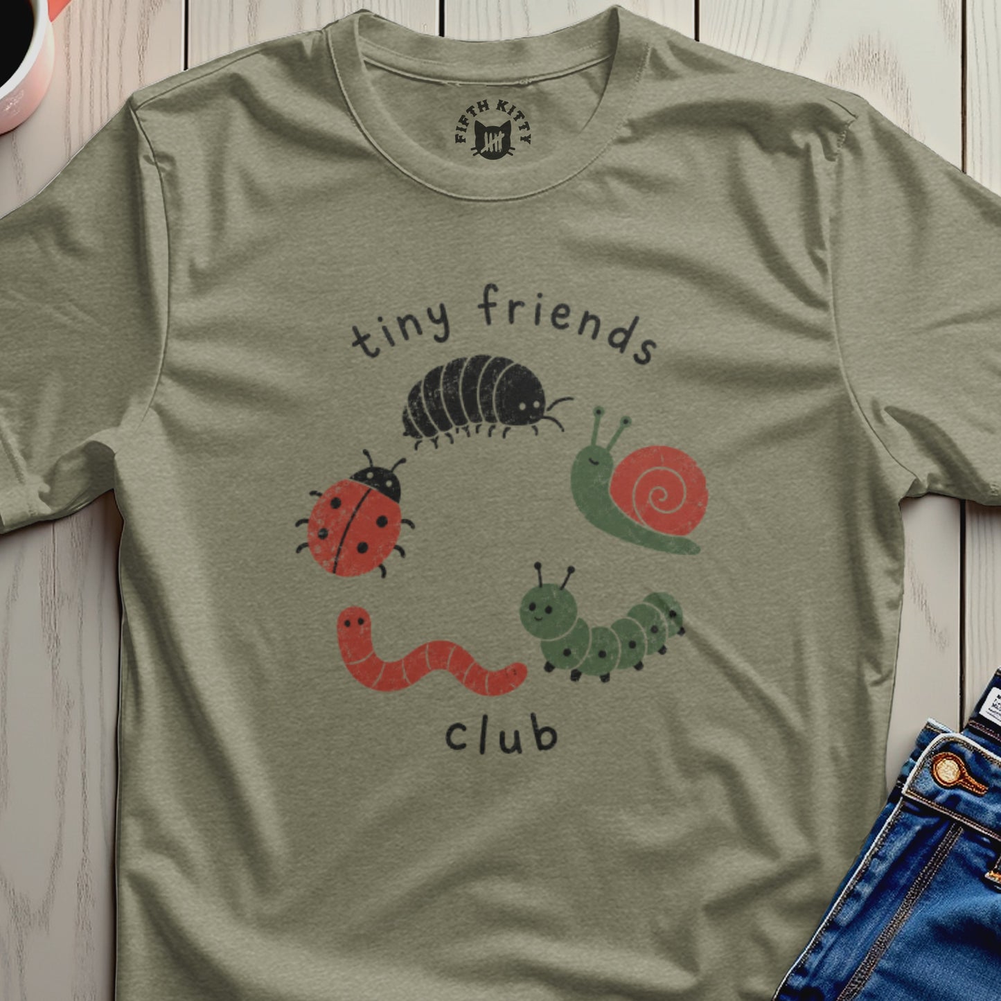 Olive green t-shirt with "tiny friends club" and cartoon insects.