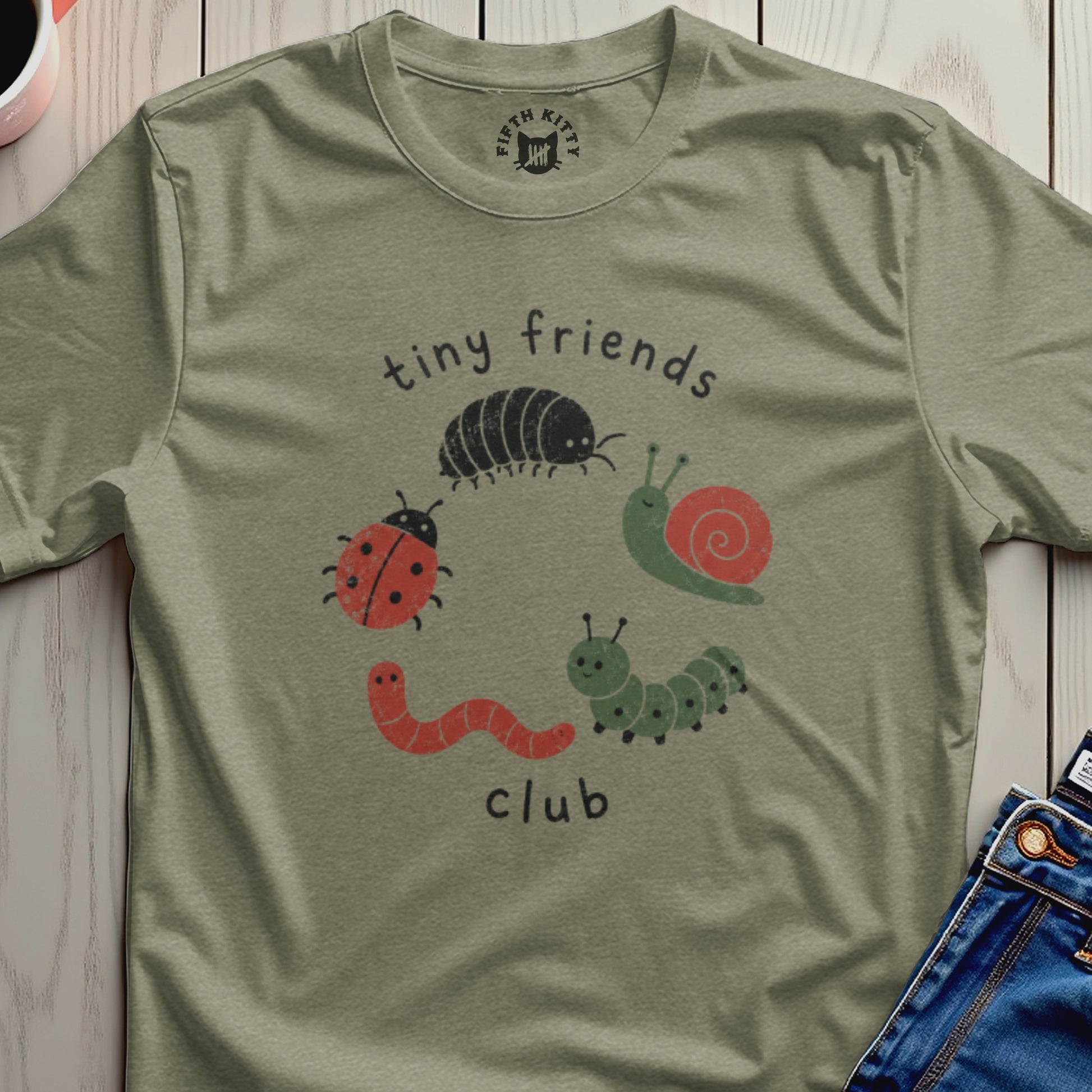 Olive green t-shirt with "tiny friends club" and cartoon insects.