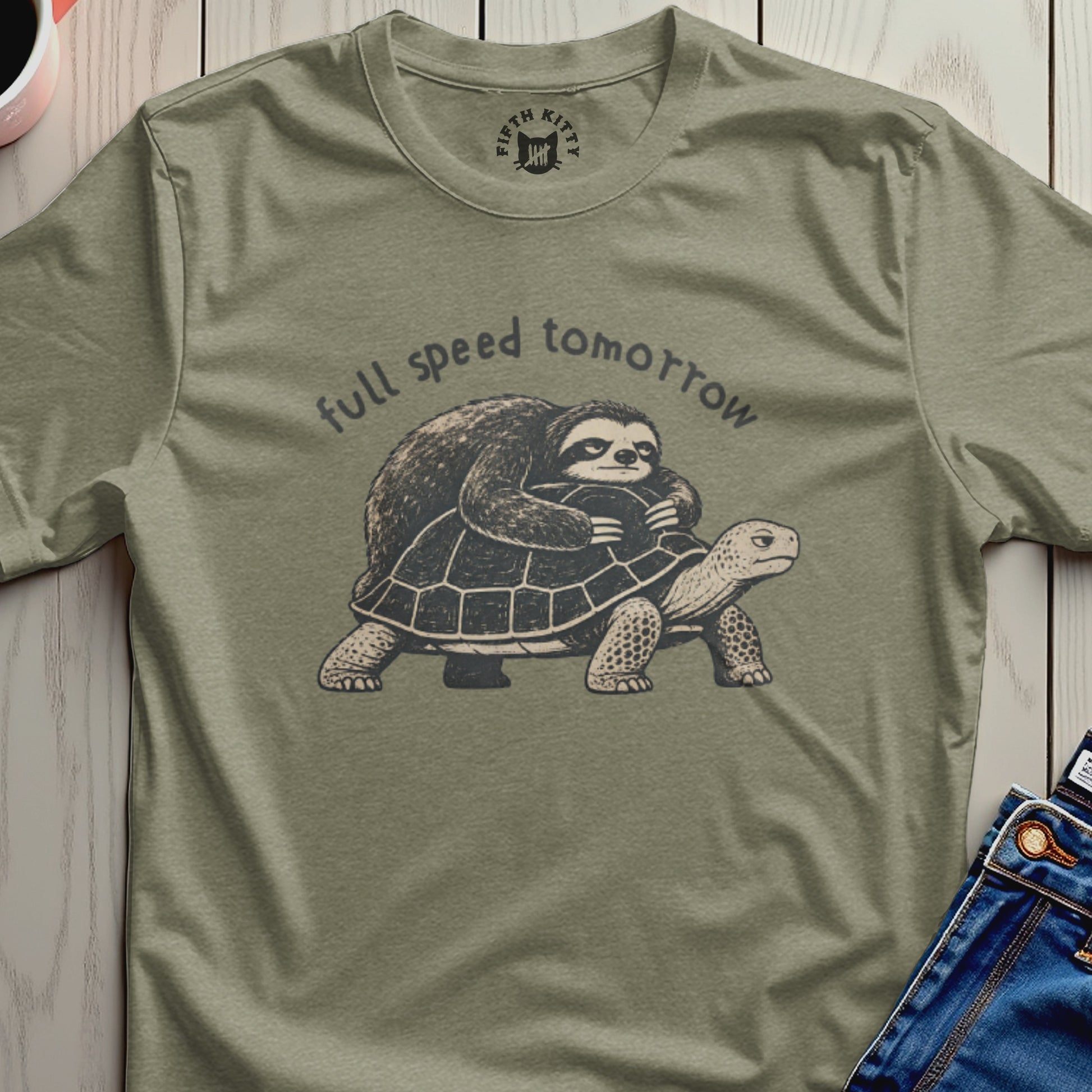 Sloth riding a turtle with "full speed tomorrow" text on a green t-shirt.