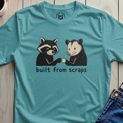 Raccoon and opossum fist bump with text "built from scraps" below.