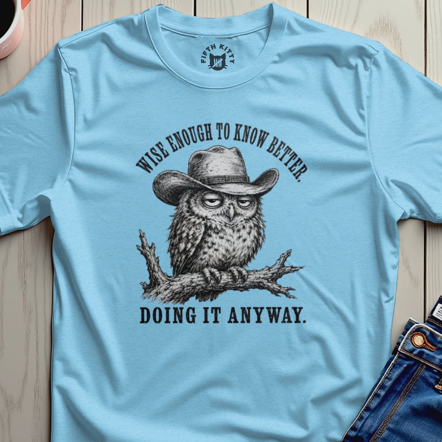 Owl wearing a cowboy hat, perched on a branch, with text.