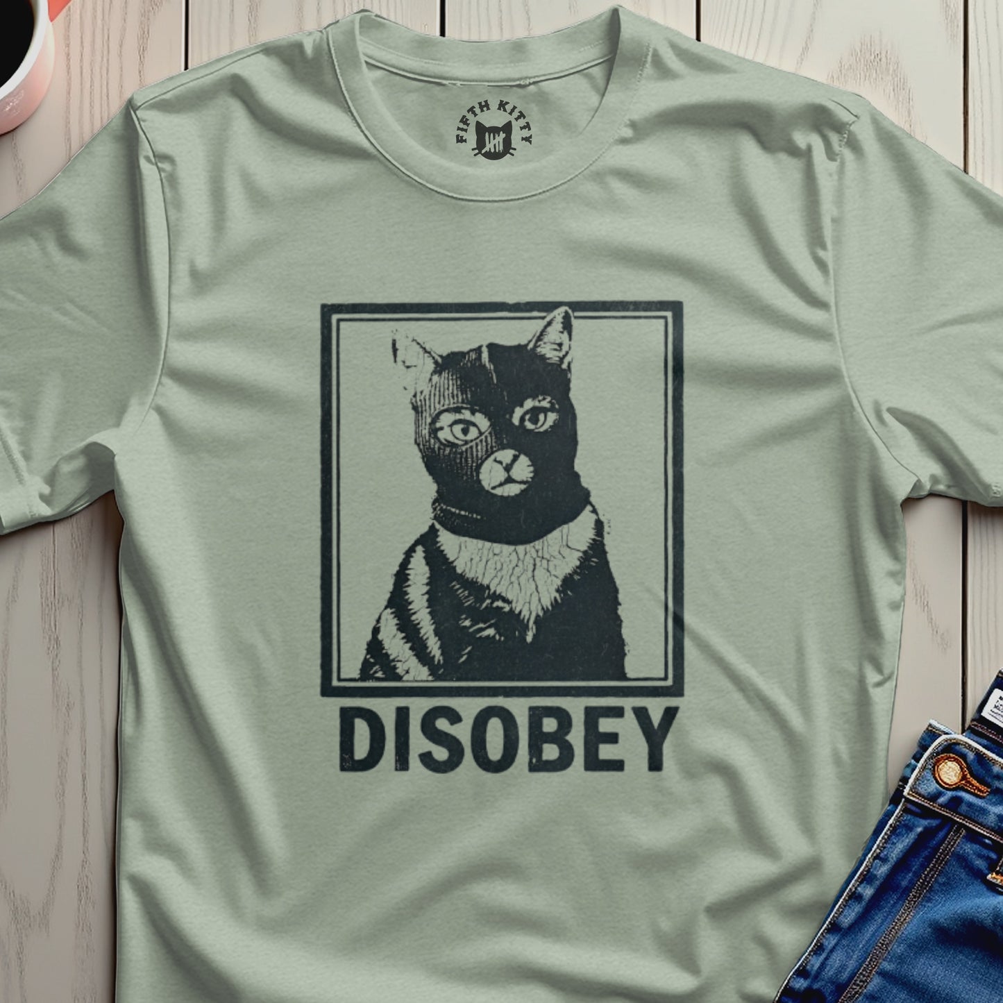 Black cat wearing a striped mask and shirt with "DISOBEY" text.