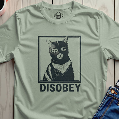 Black cat wearing a striped mask and shirt with "DISOBEY" text.