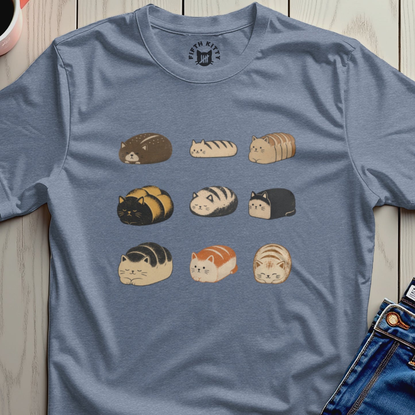 T-shirt with a print of nine different loaf-shaped cats in three rows.