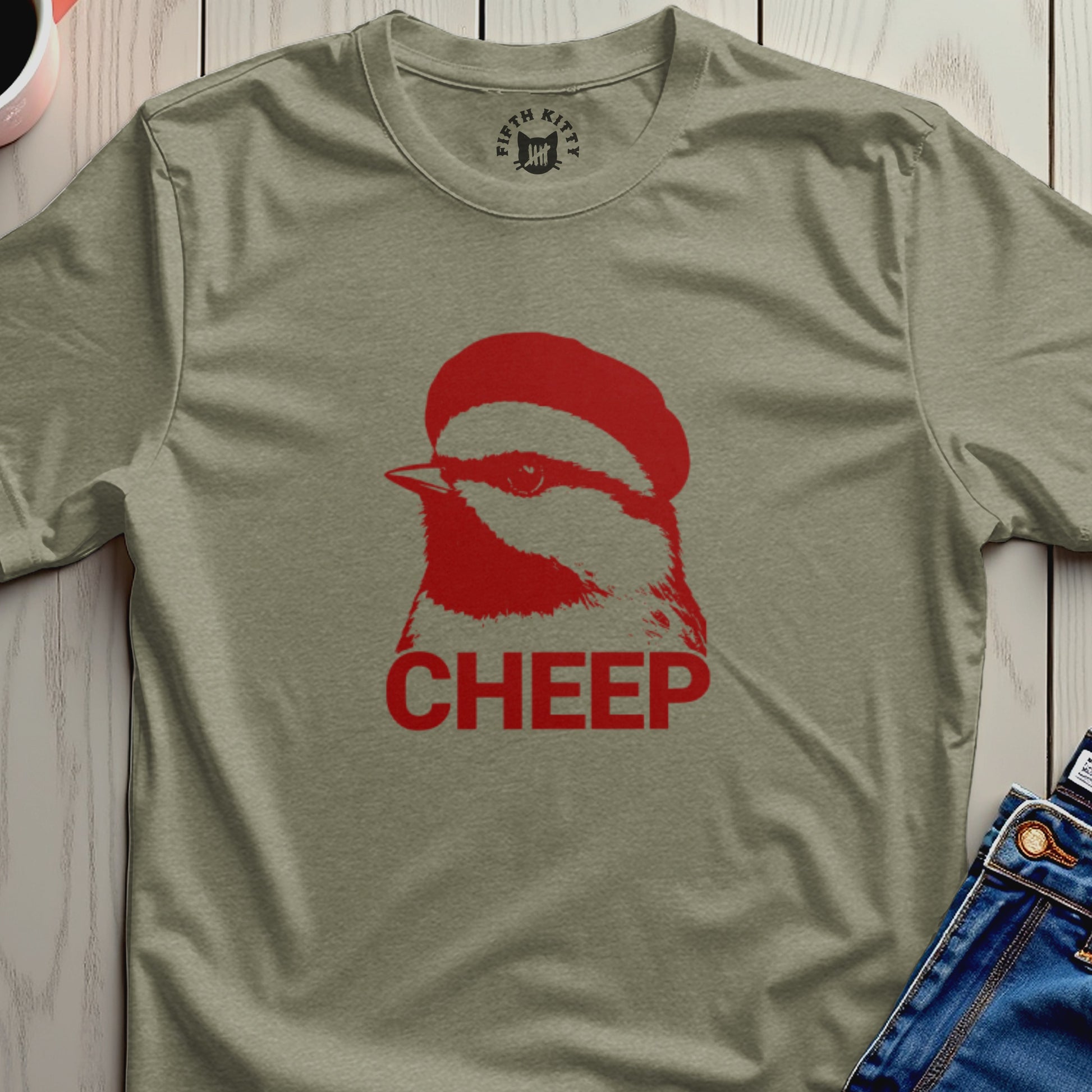 Red cheep bird graphic on a muted green t-shirt.