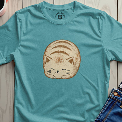 Teal t-shirt with a round, cartoon-style cat sleeping on it.