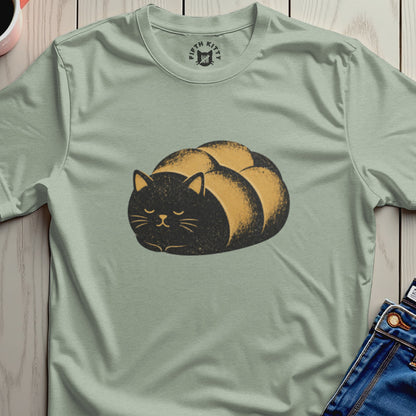Black and gold loaf cat graphic on a light green t-shirt.