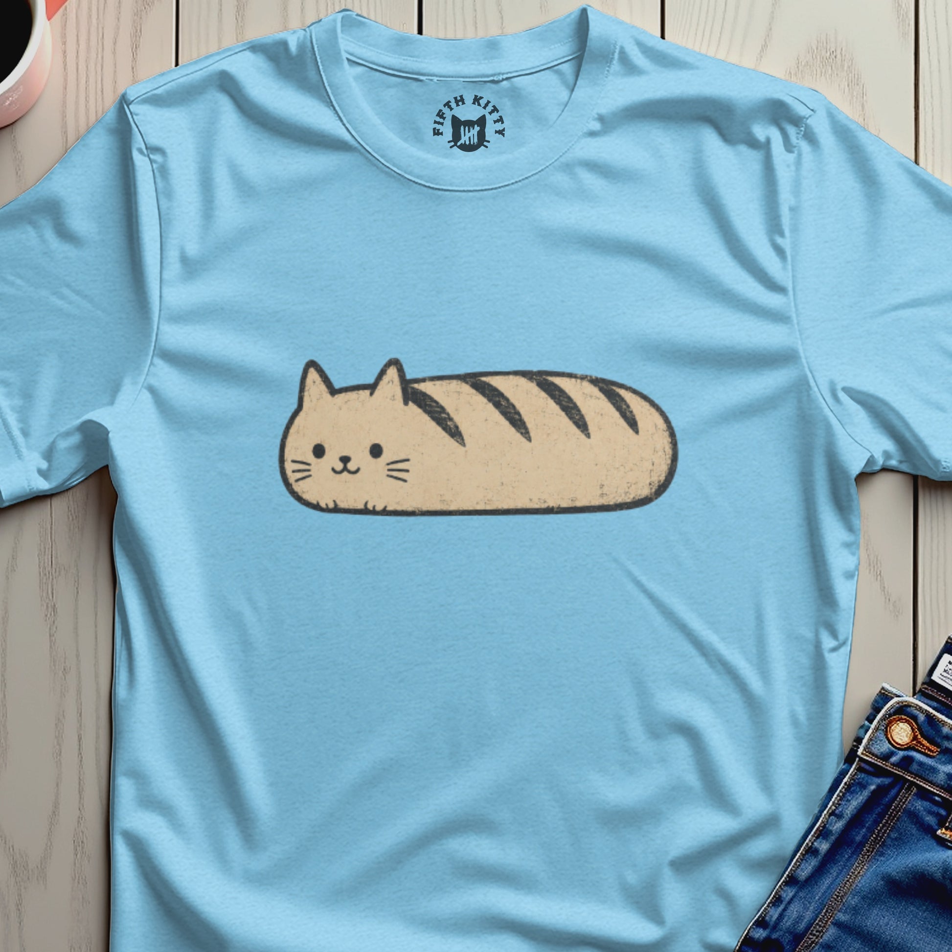 Light blue t-shirt with a cartoon cat shaped like a loaf of bread.