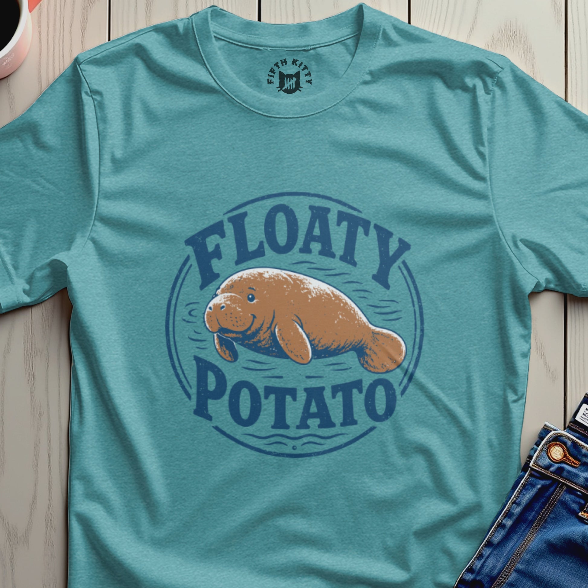 Manatee graphic with "Floaty Potato" text on a teal t-shirt.