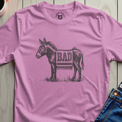 Pink t-shirt with sketch of a donkey wearing a saddle blanket that says "BAD".