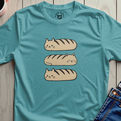 Three loaf-shaped cats with stripes are stacked on a teal t-shirt.