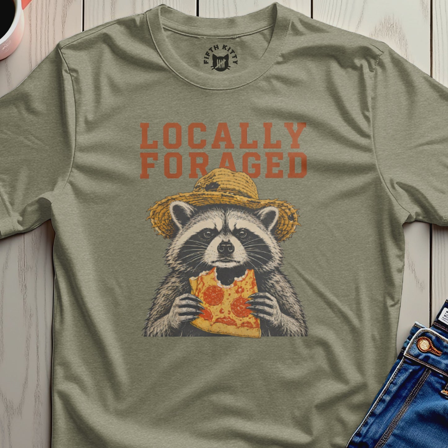 Raccoon in a straw hat eating pizza, text "Locally Foraged".