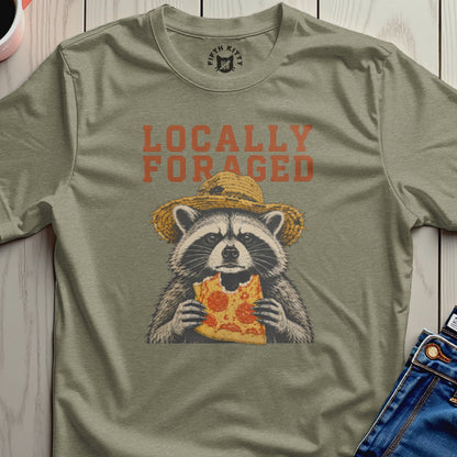 Raccoon in a straw hat eating pizza, text "Locally Foraged".