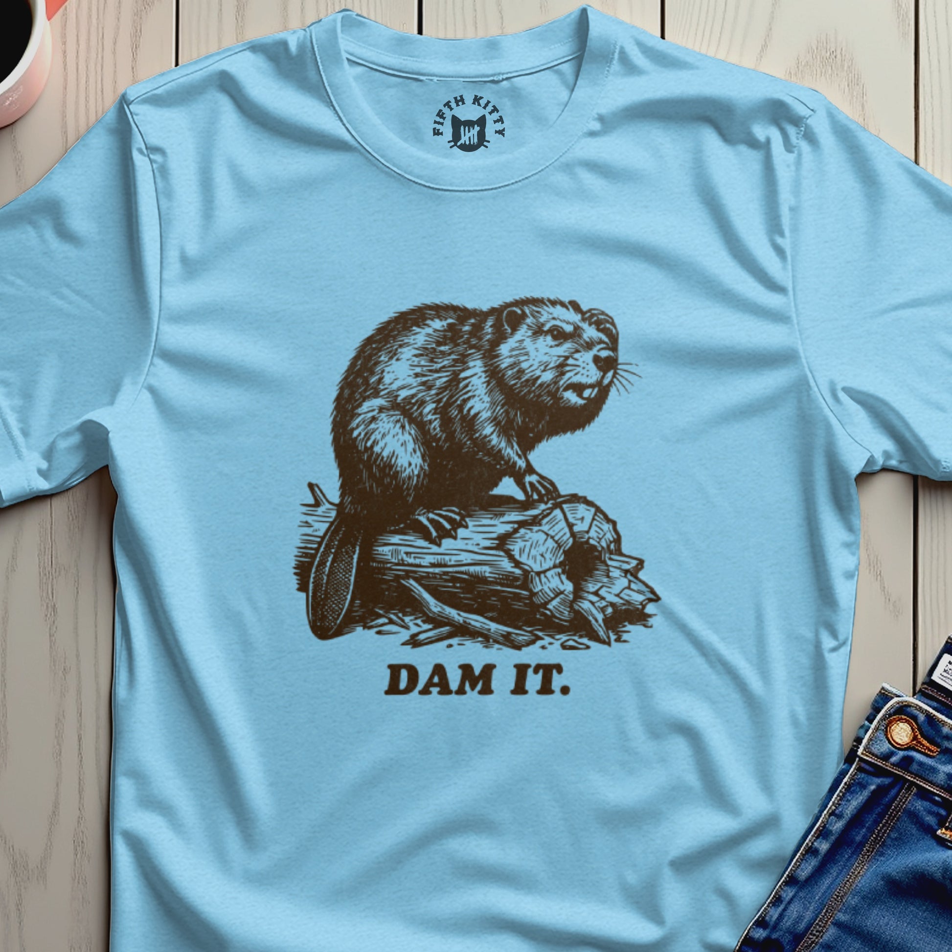 Light blue t-shirt with a beaver on a log, "DAM IT." text.