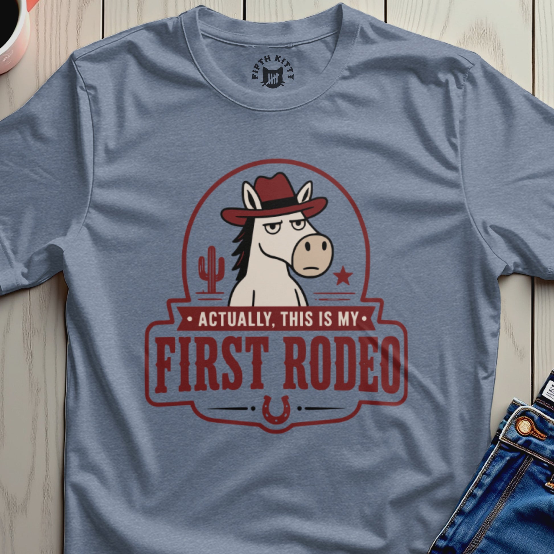 T-shirt with a cartoon horse wearing a cowboy hat and the text "Actually, this is my first rodeo."