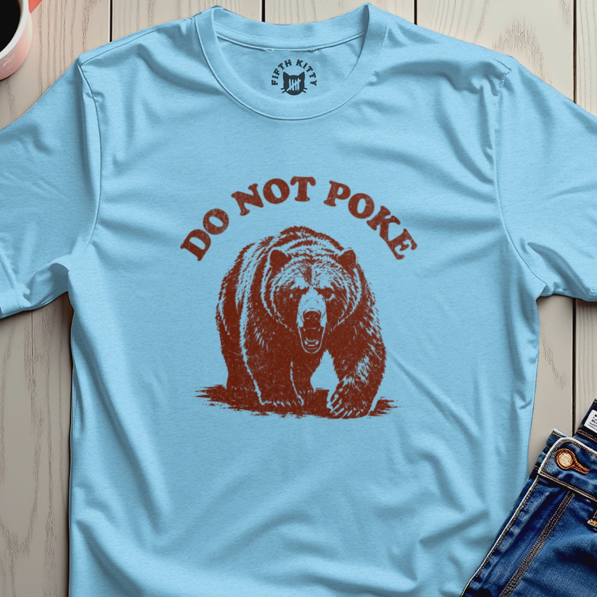 Light blue t-shirt with distressed graphic of a bear and text "DO NOT POKE".
