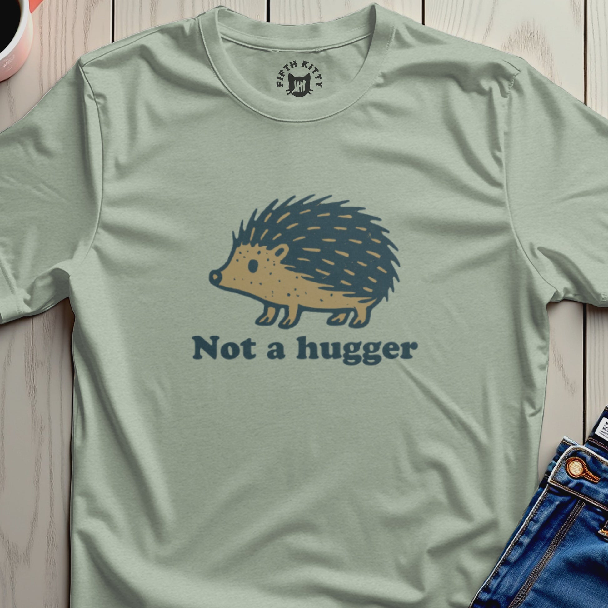Light green t-shirt with a cartoon hedgehog and the text "Not a hugger".