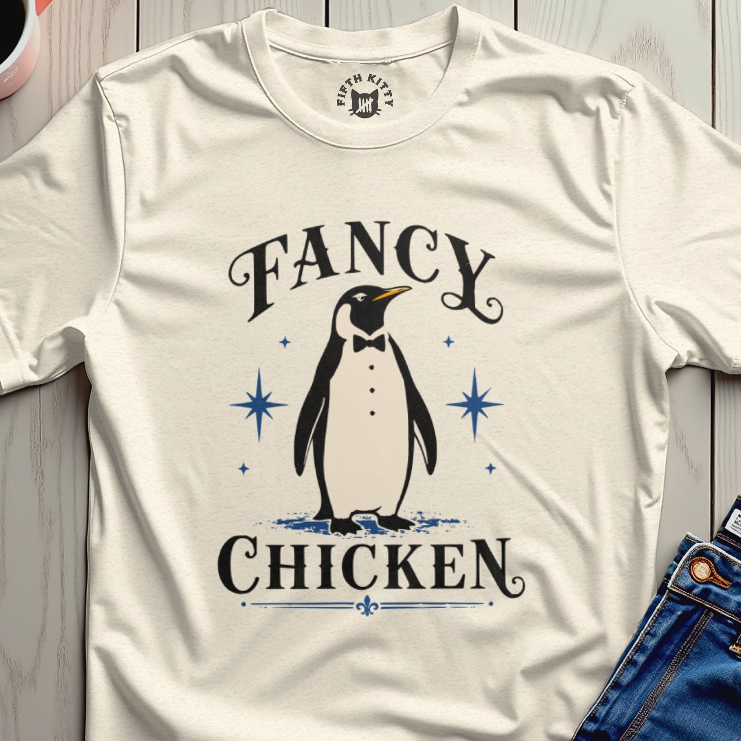 Cream t-shirt with a tuxedo-wearing penguin graphic and text "Fancy Chicken".