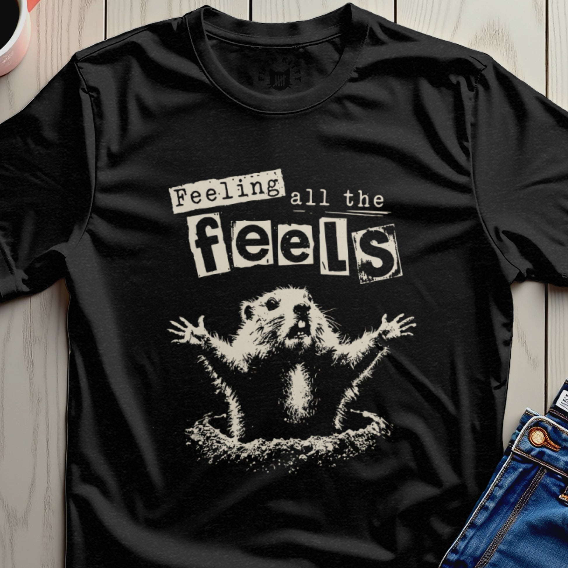 Black t-shirt with a distressed graphic of a groundhog with arms raised and text "Feeling all the feels."