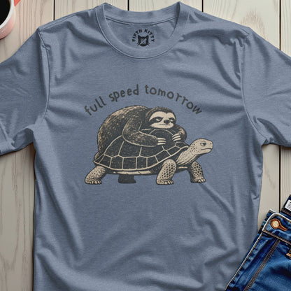 Sloth riding tortoise with text "full speed tomorrow" on slate blue t-shirt.