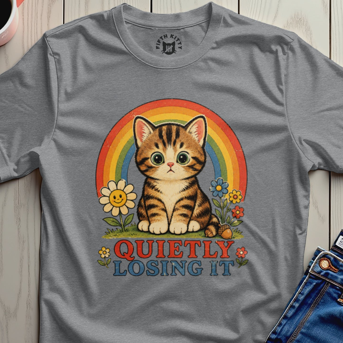 Grey t-shirt with a cartoon cat, rainbow, flowers, and text "QUIETLY LOSING IT".