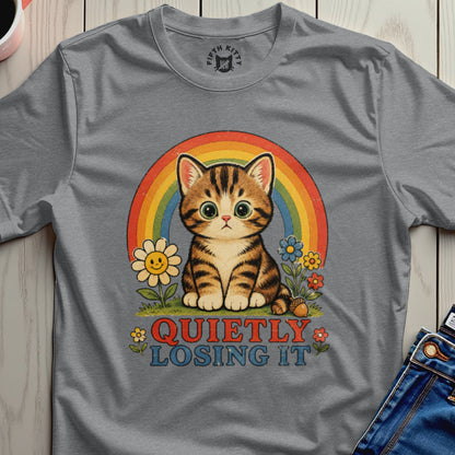 Grey t-shirt with a cartoon cat, rainbow, flowers, and text "QUIETLY LOSING IT".