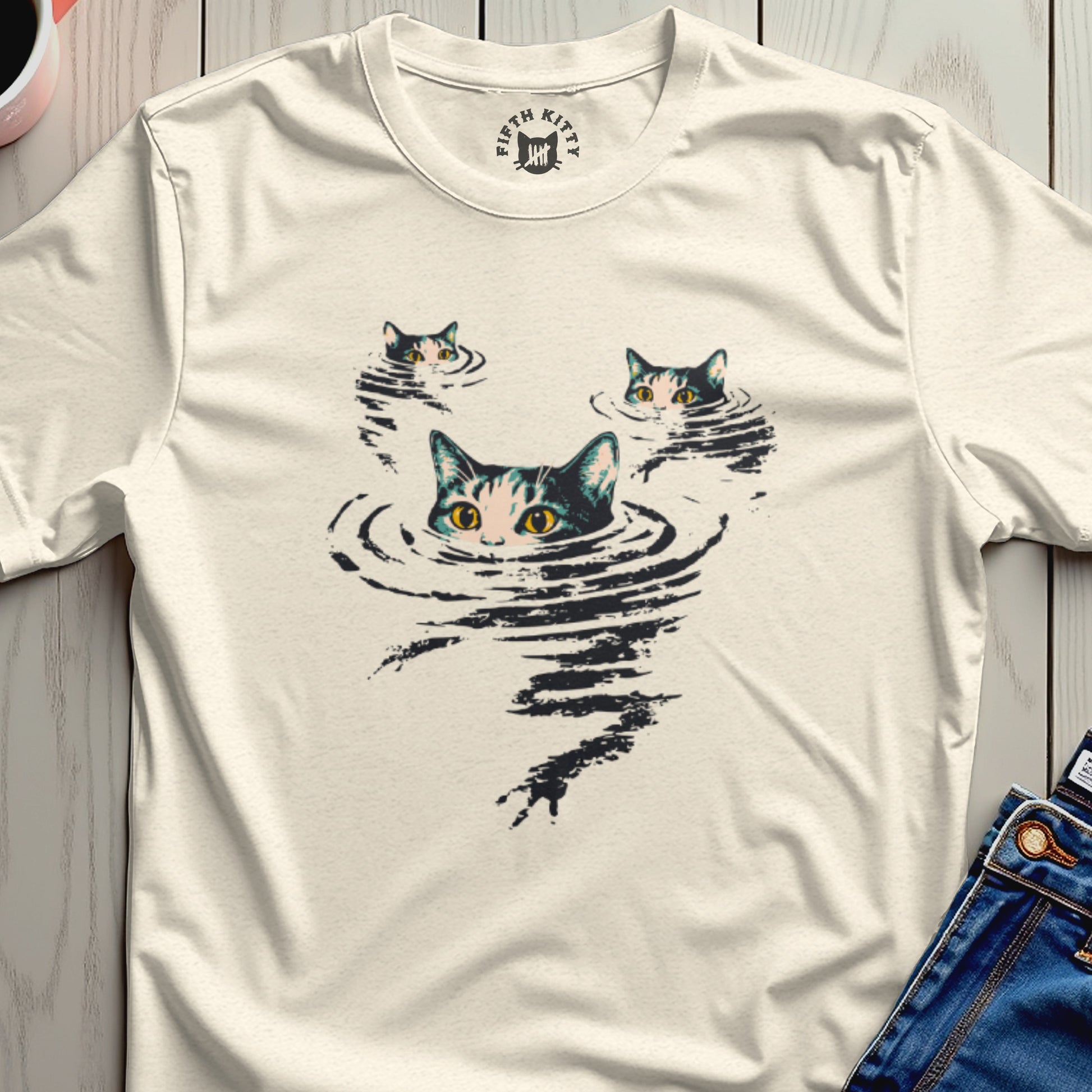 Cream t-shirt with three cats' faces emerging from dark water.