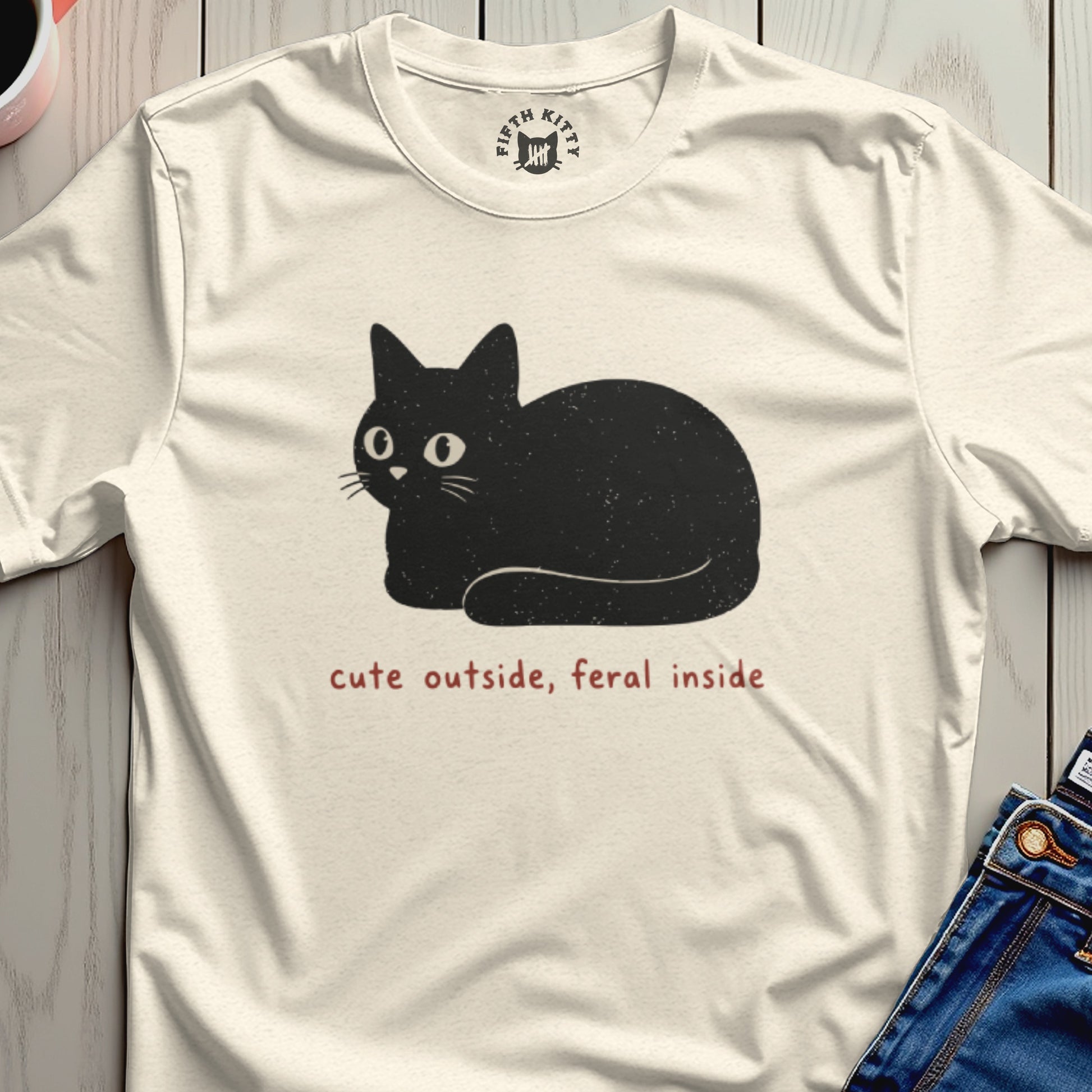 Cream t-shirt with black cat graphic and text "cute outside, feral inside".