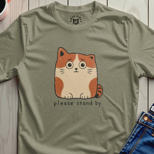T-shirt with a drawing of a worried cat and the text "please stand by".