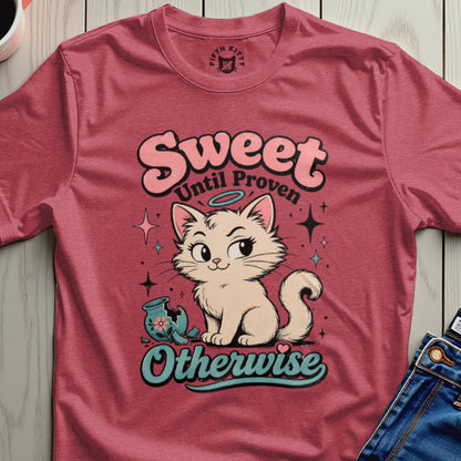 Cat graphic with "Sweet Until Proven Otherwise" text on a pink t-shirt.